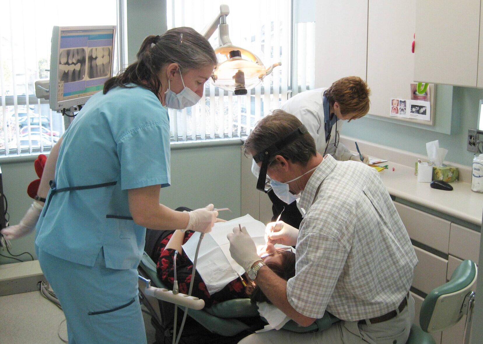 Dental Practice Treatment Room with patient - Patient facilitation and dental team training